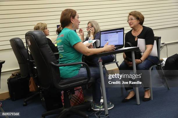 Maria Mena , an insurance agent from Sunshine Life and Health Advisors, speaks with Elena Blondin as she shops for insurance under the Affordable...