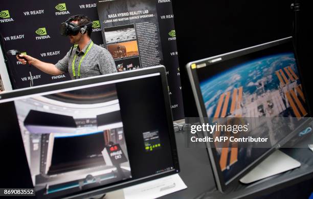 Rodolfo Campos uses a virtual reality headset during a NASA Hybrid Reality Lab demonstration at the NVIDIA GPU Technology Conference, which showcases...