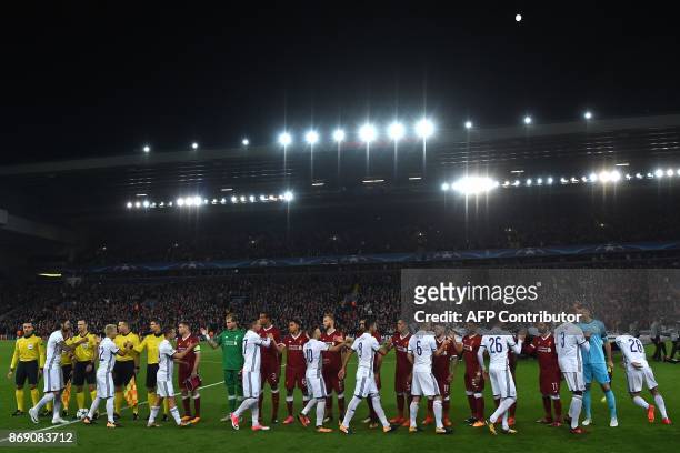 Players shake hands before the UEFA Champions League Group E football match between Liverpool and NK Maribor at Anfield in Liverpool, north-west...