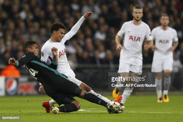 Real Madrid's Brazilian midfielder Casemiro tackles Tottenham Hotspur's English midfielder Dele Alli during the UEFA Champions League Group H...