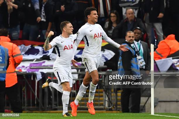 Tottenham Hotspur's English midfielder Dele Alli celebrates with Tottenham Hotspur's English defender Kieran Trippier after scoring the opening goal...