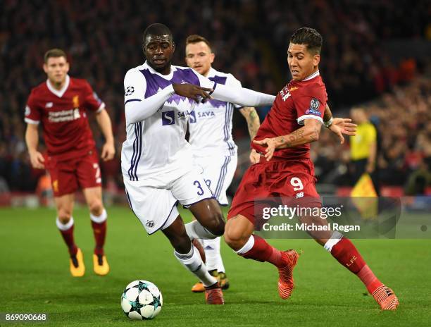 Jean Claude Billong of NK Maribor and Roberto Firmino of Liverpool battle for possession during the UEFA Champions League group E match between...