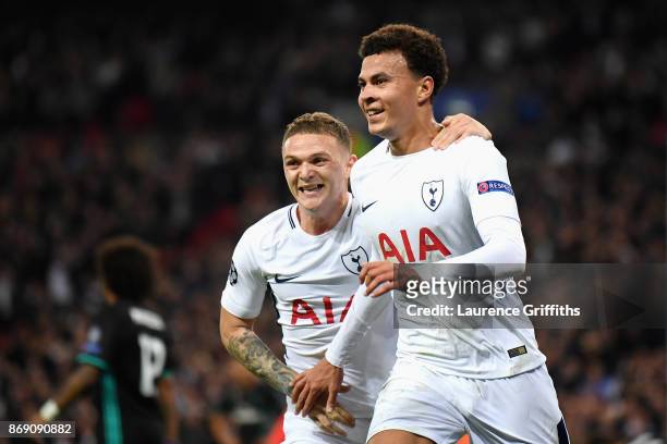 Dele Alli celebrates scoring his side's first goal with Kieran Trippier of Tottenham Hotspur during the UEFA Champions League group H match between...