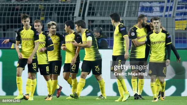 Raphael Guerreiro of Borussia Dortmund celebrates scoring his sides first goal with his Borussia Dortmund team mates during the UEFA Champions League...