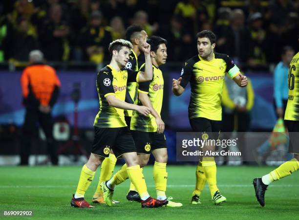 Raphael Guerreiro of Borussia Dortmund celebrates scoring his sides first goal with his Borussia Dortmund team mates during the UEFA Champions League...
