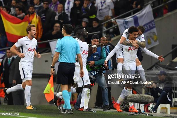 Tottenham Hotspur's English midfielder Dele Alli celebrates with Tottenham Hotspur's English defender Kieran Trippier after scoring the opening goal...