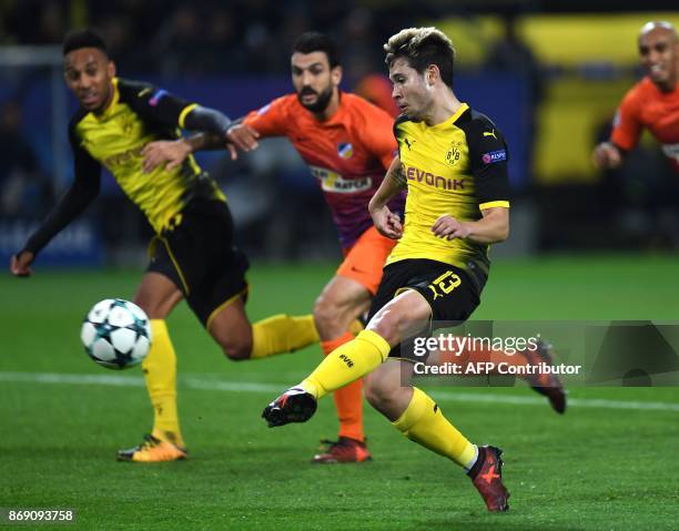 Dortmund's Portuguese defender Raphael Guerreiro scores the opening goal during the UEFA Champions League Group H football match BVB Borussia...