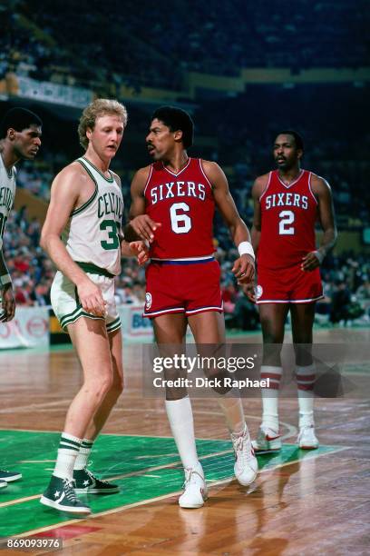 Julius Erving of the Philadelphia 76ers and Larry Bird of the Boston Celtics battle for position circa 1985 at the Boston Garden in Boston,...