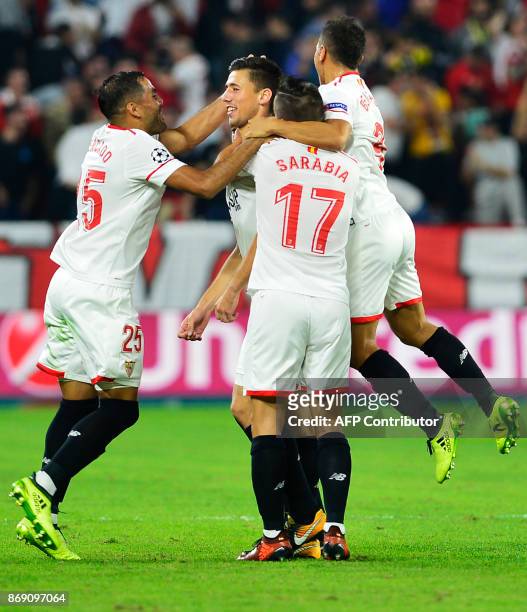 Sevilla's French defender Clement Lenglet celebrates with teammates after scoring a goal during the UEFA Champions League group E football match...