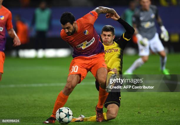 Nicosia's Cypriot defender Georgios Merkis and Dortmund's midfielder Dortmund's US midfielder Christian Pulisic vie for the ball during the UEFA...