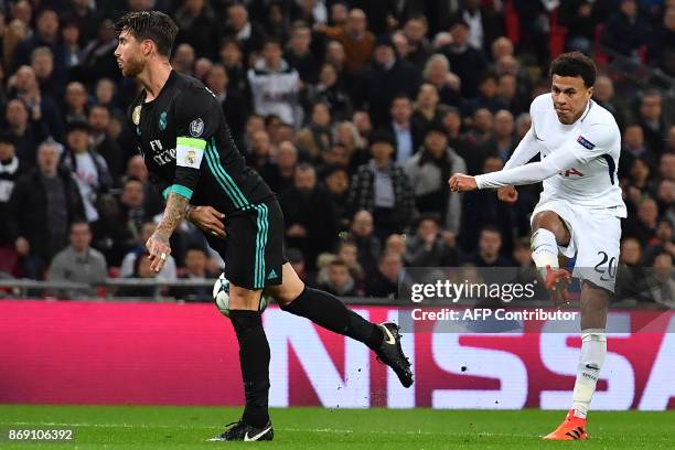 Tottenham Hotspur's English midfielder Dele Alli has this shot deflected off Real Madrid's Spanish defender Sergio Ramos for their second goal during...