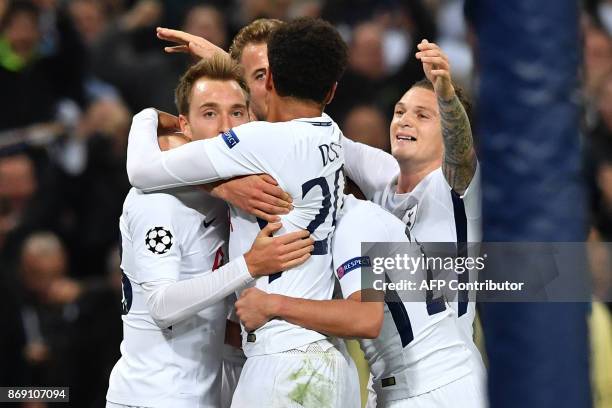 Tottenham Hotspur's Danish midfielder Christian Eriksen celebrates with teammates after scoring their third goal during the UEFA Champions League...