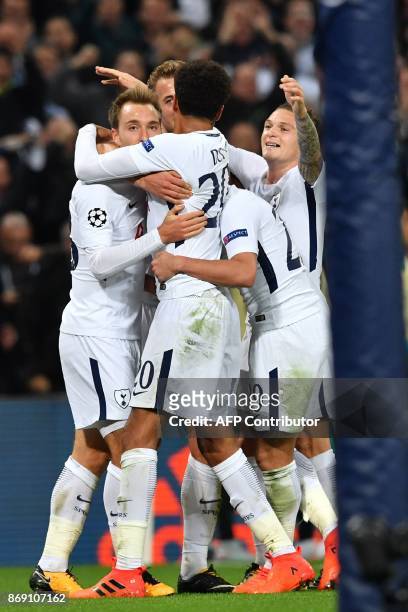 Tottenham Hotspur's Danish midfielder Christian Eriksen celebrates with teammates after scoring their third goal during the UEFA Champions League...