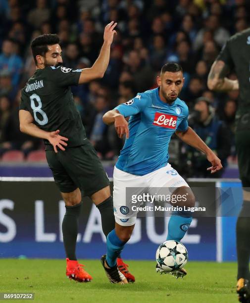 Fauozi Ghoulam of Napoli competes for the ball with Ilkay Gundogan of Manchester City during the UEFA Champions League group F match between SSC...
