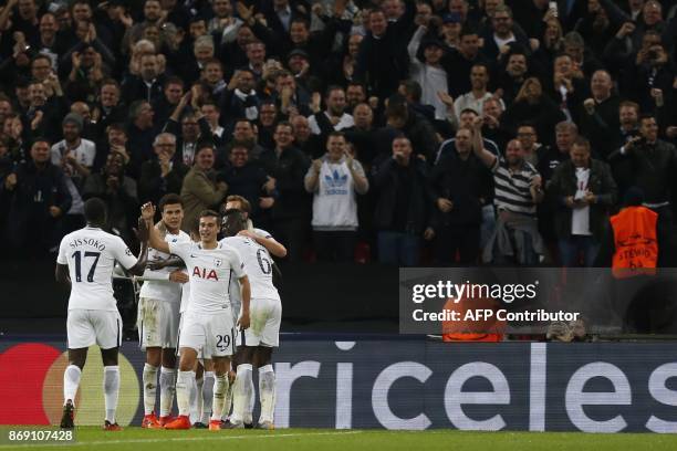 Tottenham players celebrate their third goal during the UEFA Champions League Group H football match between Tottenham Hotspur and Real Madrid at...