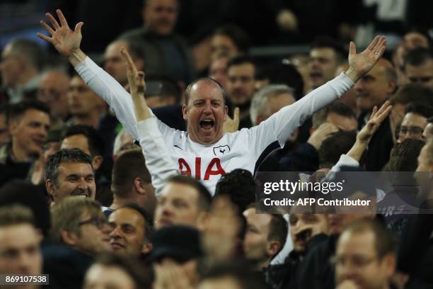 Tottenham fans celebrate their third goal during the UEFA Champions League Group H football match between Tottenham Hotspur and Real Madrid at...
