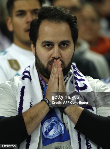 Real Madrid fans react after Tottenham scored their third goal during the UEFA Champions League Group H football match between Tottenham Hotspur and...