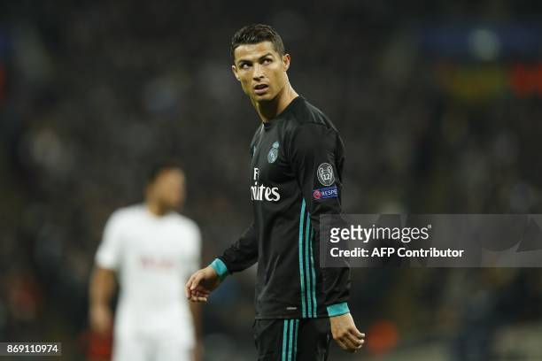 Real Madrid's Portuguese striker Cristiano Ronaldo reacts after Tottenham scored their third goal during the UEFA Champions League Group H football...