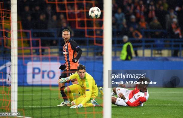 Shakhtar's Ukrainian midfielder Marlos eyes the ball as he scores a goal past Feyenoord's Australian goalkeeper Brad jones during the UEFA Champions...