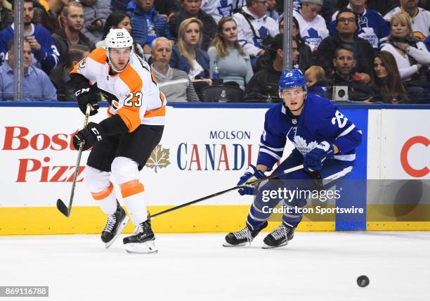 Toronto Maple Leafs center William Nylander and Philadelphia Flyers defenseman Brandon Manning chase down a puck in the second period during a game...