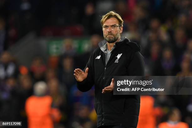 Liverpool's German manager Jurgen Klopp applauds supporters on the pitch after the UEFA Champions League Group E football match between Liverpool and...