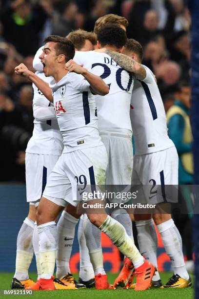 Tottenham Hotspur's English midfielder Harry Winks and teammates celebrate Tottenham Hotspur's Danish midfielder Christian Eriksen's goal during the...