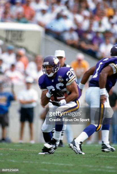 Robert Smith of the Minnesota Vikings carries the ball against the Tampa Bay Buccaneers during an NFL football game October 15, 1995 at Tampa Stadium...