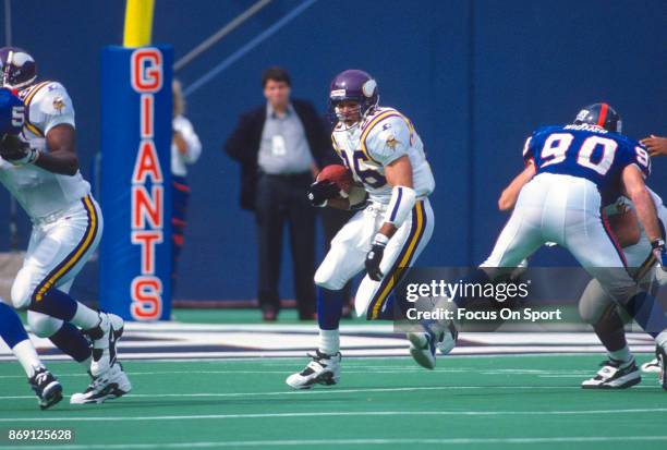 Robert Smith of the Minnesota Vikings carries the ball against the New York Giants during an NFL football game September 29, 1996 at Giants Stadium...