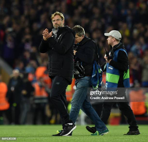 Jurgen Klopp manager of Liverpool shows his appreciation to the fans at the end of the UEFA Champions League group E match between Liverpool FC and...