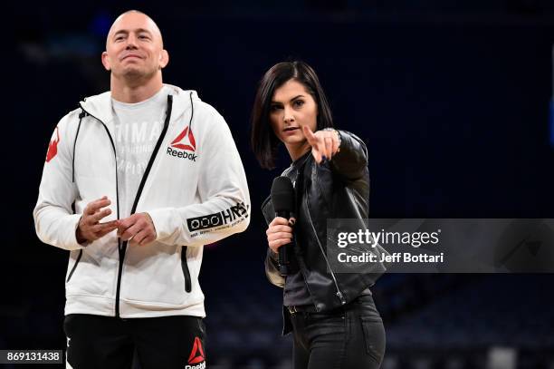 Georges St-Pierre of Canada and UFC host Megan Olivi interact with fans and media inside Madison Square Garden on November 1, 2017 in New York City.