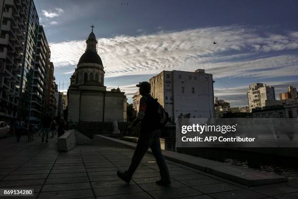 Man walks close to the Cathedral Basilica Shrine of Our Lady of the Rosary in Rosario, Santa Fe province on November 1, 2017. Five Argentine citizens...