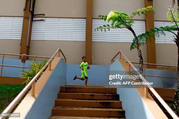 Angel Elier Rivera plays in the school playground in Barranquitas, Puerto Rico October 31, 2017. Twenty people from Barranquitas have been living for...