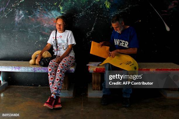 Rosa Esther Rosario and her husband Hector Santana sit at the school lobby in Barranquitas, Puerto Rico October 31, 2017. Twenty people from...