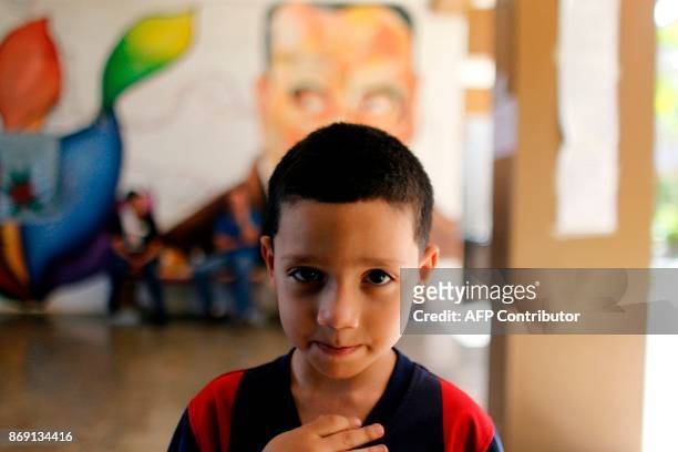 Adriel Isaac Rosario looks at the camera at the school lobby in Barranquitas, Puerto Rico October 31, 2017. Twenty people from Barranquitas have been...