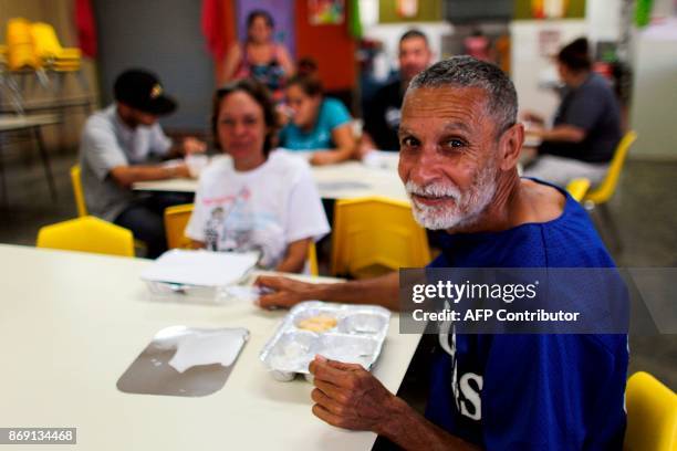 Hector Santana takes breakfast at the school canteen in Barranquitas, Puerto Rico October 31, 2017. Twenty people from Barranquitas have been living...