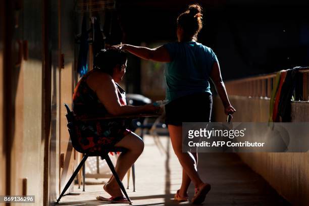 Woman greets a fellow displaced in Barranquitas, Puerto Rico October 31, 2017. Twenty people from Barranquitas have been living for the past 42 days...