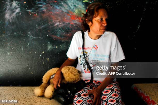 Rosa Esther Rosario sits at the school lobby in Barranquitas, Puerto Rico October 31, 2017. Twenty people from Barranquitas have been living for the...