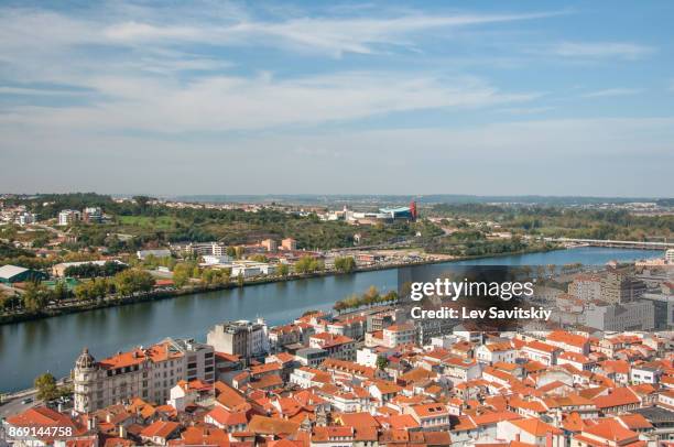 coimbra cityscape and santa clara bridge on mondego river. coimbra in central portugal, is famous for its university. coimbra aerial view from bell clock tower in a sunny day. - mondego stock pictures, royalty-free photos & images