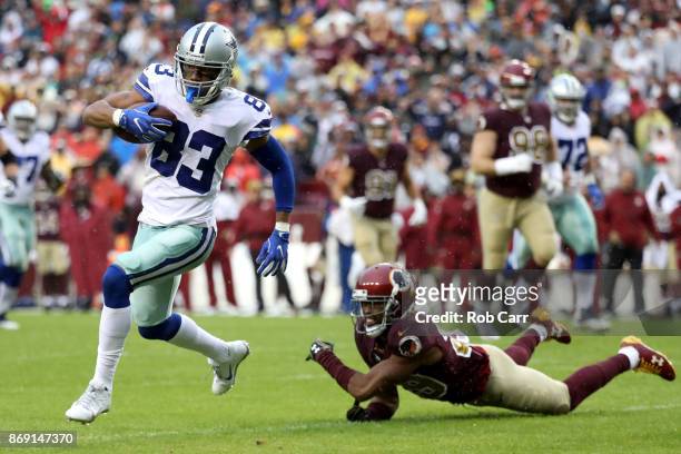 Wide receiver Terrance Williams of the Dallas Cowboys catches a pass in front of cornerback Kendall Fuller of the Washington Redskins at FedEx Field...