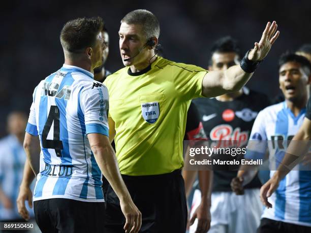 Ivan Pillud of Racing Club argues with Referee Anderson Daronco of Brasil gestures during a second leg match between Racing Club and Libertad as part...