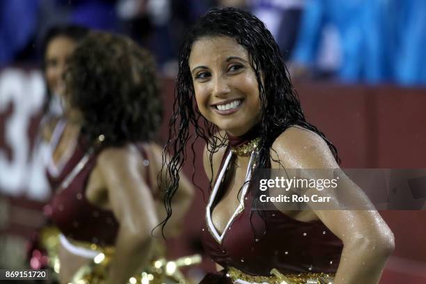 Washington Redskins cheerleader stands on the sidelines during the fourth quarter of the Redskins lose to the Dallas Cowboys at FedEx Field on...