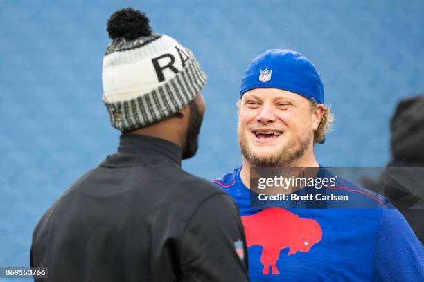 Manuel of the Oakland Raiders speaks with Eric Wood of the Buffalo Bills before the game at New Era Field on October 29, 2017 in Orchard Park, New...