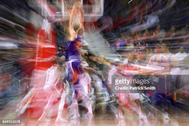 Alex Len of the Phoenix Suns dunks in front of Tim Frazier of the Washington Wizards during the first half at Capital One Arena on November 01, 2017...