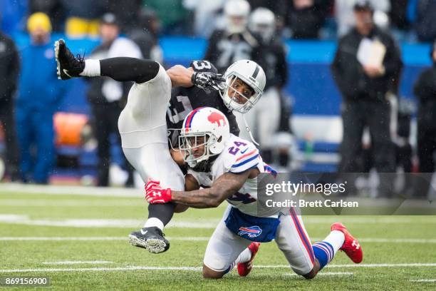 Leonard Johnson of the Buffalo Bills tackles DeAndre Washington of the Oakland Raiders on a play that resulted in a Buffalo Bills defensive touchdown...