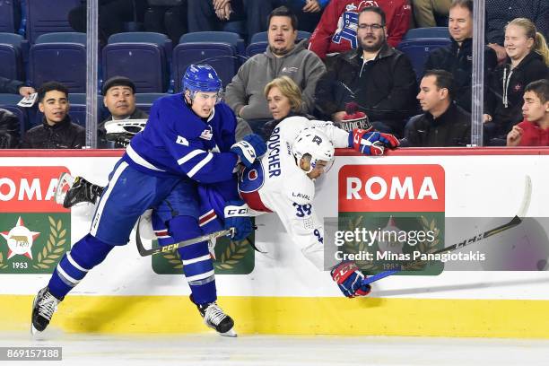 Justin Holl of the Toronto Marlies checks Jordan Boucher of the Laval Rocket during the AHL game at Place Bell on November 1, 2017 in Laval, Quebec,...