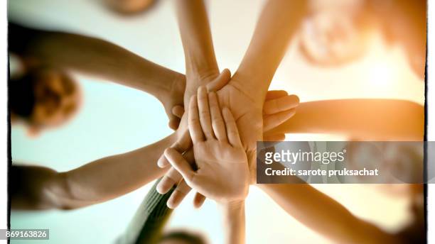 team teamwork join hands partnership concept . - partnership teamwork stock-fotos und bilder