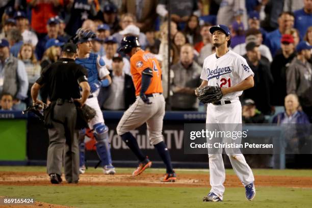 Yu Darvish of the Los Angeles Dodgers reacts after George Springer of the Houston Astros hit a two-run home run during the second inning in game...