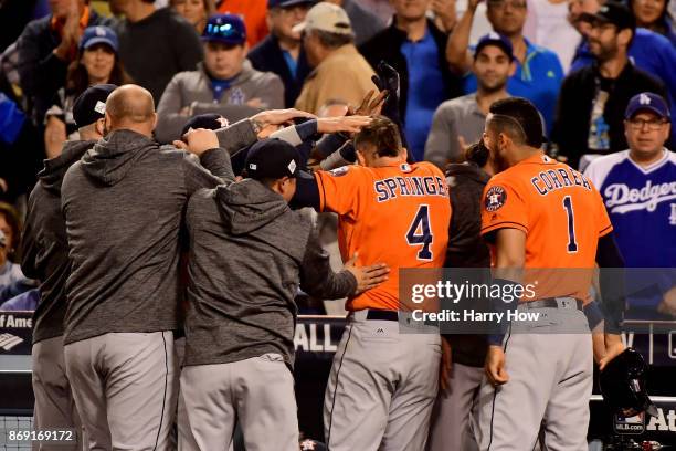 George Springer of the Houston Astros celebrates with teammates after hitting a two-run home run during the second inning against the Los Angeles...