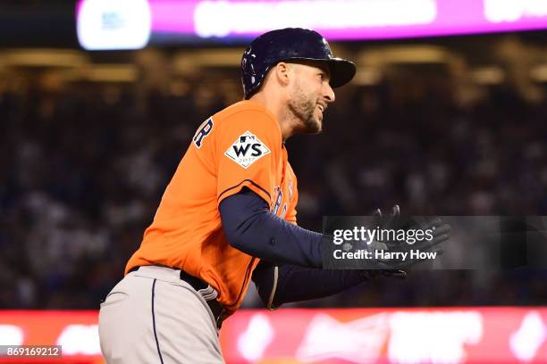 George Springer of the Houston Astros celebrates after hitting a two-run home run during the second inning against the Los Angeles Dodgers in game...