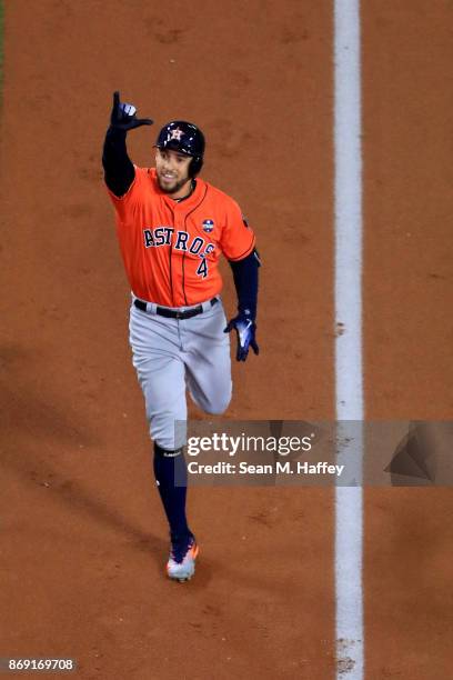 George Springer of the Houston Astros celebrates after hitting a two-run home run during the second inning against the Los Angeles Dodgers in game...